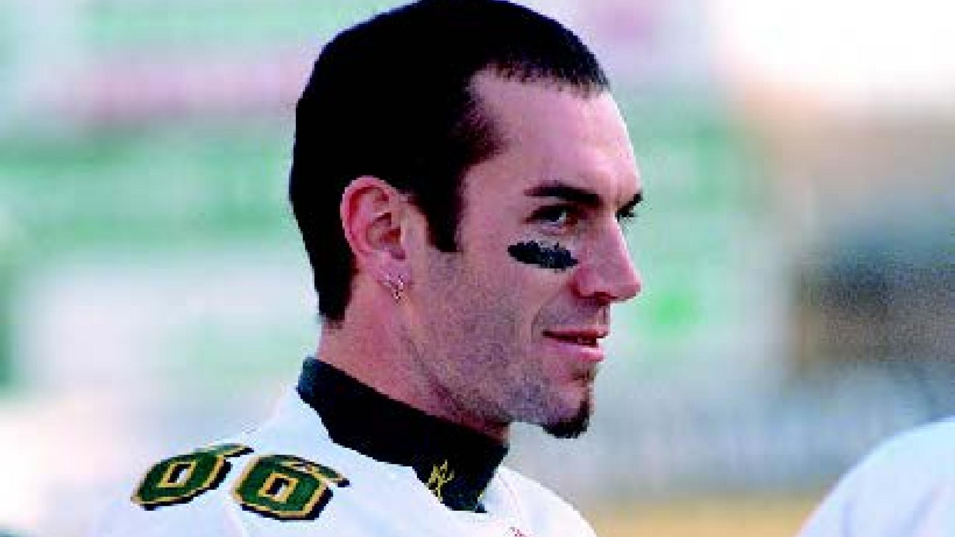 Scott Robinson looks off field at a football game.